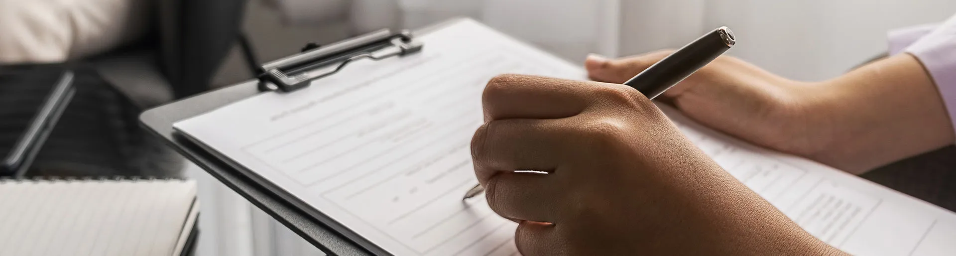 Person writing an evaluation